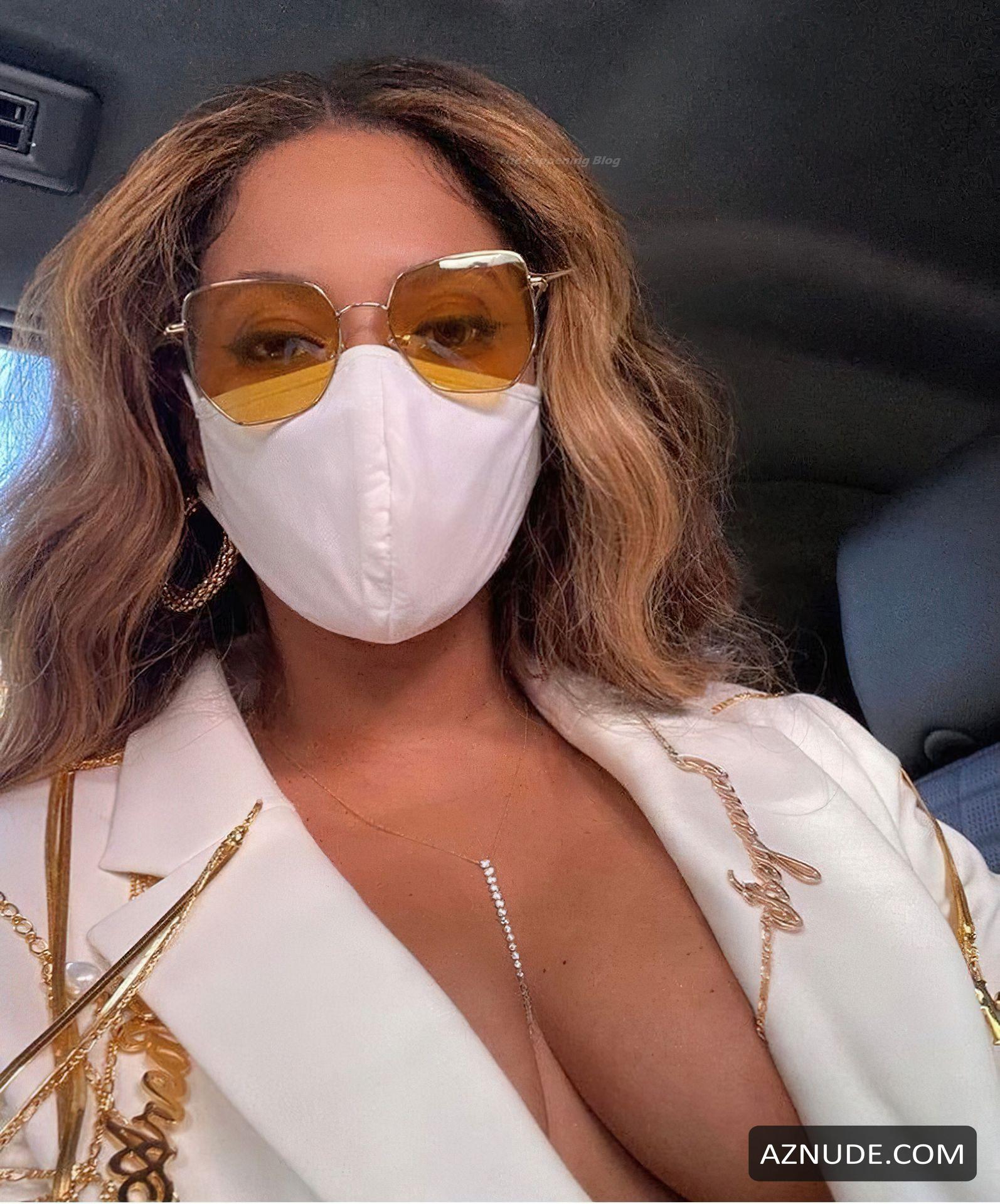Beyonce Sexy Shows Off Her Cleavage Posing Braless In A White Pantsuit