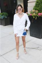 Bella ThorneSexy in Bella Thorne wearing white mini-dress with matching heels and carrying mini Jacquemus tote in New York