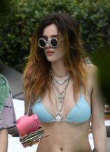 Bella ThorneSexy in Bella Thorne Sexy in blue string bikini top and denim shorts as she relaxes by the pool with sister Dani in Miami