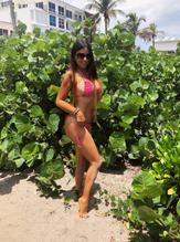 Claudia Romani posing in a red mini-bikini at Delray Beach