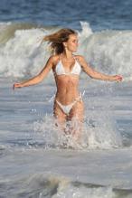 Dasha Inyutkina in a white bikini while shooting a new advert for 138 Water in Malibu