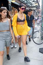 Dua Lipa Sexy in a bra top under a yellow outfit in New York City