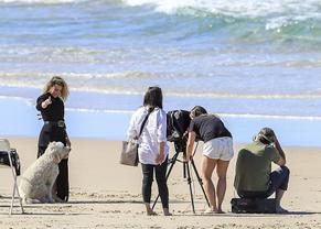 Elsa PatakySexy in Elsa Pataky poses with the family dog Sunny during a beach fashion photoshoot in Byron Bay