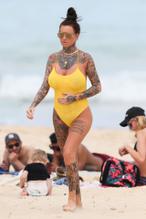 JEMMALUCYPICTUREDINAYELLOWSWIMSUITHOLDINGHERSTOMACHATABEACHINSYDNEY - NUDE STORY