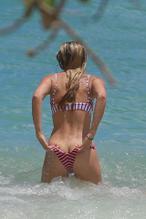 Josie Canseco scorches the Hawaiian sand in a tiny striped bikini