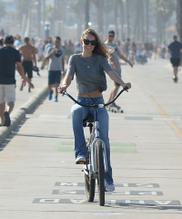 Josh Brolin and Kathryn Boyd ride bicycles by the beach in Santa Monica, California