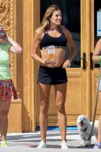 Kelly Bensimon take her dog for a walk while enjoying the sights in Palms Beach