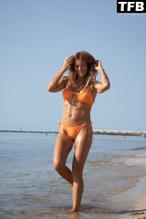 Kelly Bensimon Sexy in Kelly Bensimon Sexy Poses Showcasing Her Hot Figure Wearing An Orange Bikini On The Beach In A Photoshoot