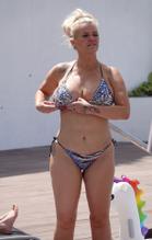 Kerry Katona Sexy in Kerry Katona showing off a whole load of cleavage in her skimpy multicolored bikini