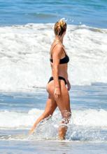 Rosie Huntington-WhiteleySexy in Huntington-Whiteley shows off her amazing beach body in a black bikini while enjoying a beach day in Malibu