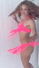 Shakira flaunts her curves in a neon pink bikini that she helped design